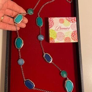 Silver necklace w/blue, teal and turquoise colored ‘gemstones.’